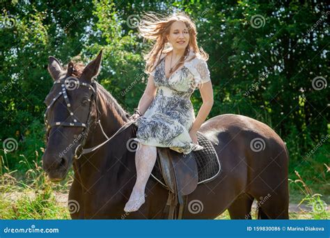 Beautiful Caucasian Young Girl Walking With A Horse And Enjoys