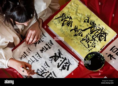 Top View Of Young Woman Learning To Write Chinese Characters During