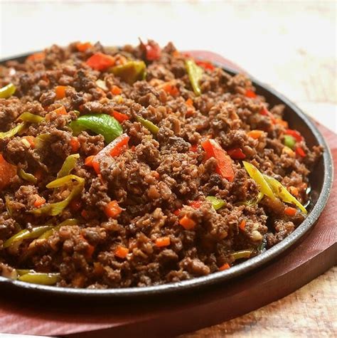 Bopis With Minced Pork Lungs Carrots And Peppers On A Sizzling Plate