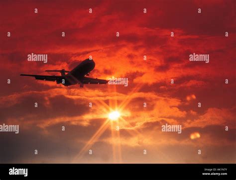 Commercial Passenger Jet Aircraft Flying Into Sunset Stock Photo Alamy