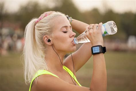 Download Blonde Woman Drinking Water From Bottle Wallpaper