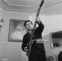 Scottish actor Vincent Winter playing a bass guitar at his home, UK ...