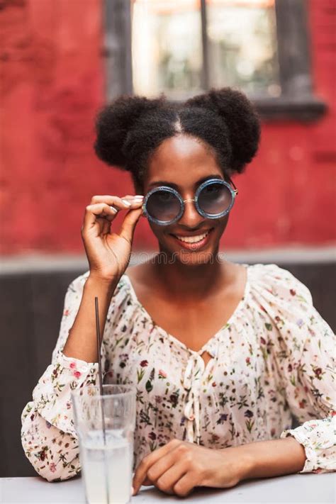 Smiling African Girl In Blouse And Sunglasses On Head Happily Holding