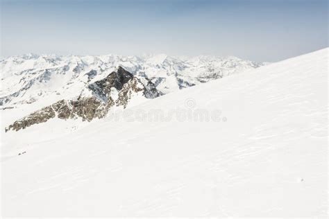 Snow Covered Slope With Mountain Ridge In The Back Stock Image Image