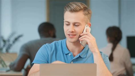 Young Business Man Talking Mobile Phone At Workplace Portrait Of Young