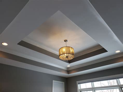 Double Tray Ceiling With Recessed Lighting And Decorative Chandelier
