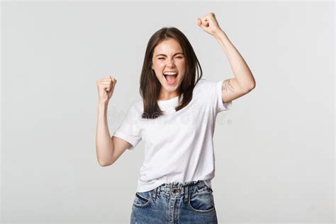 Cheerful Attractive Brunette Girl Fist Pump And Smiling With Rejoice