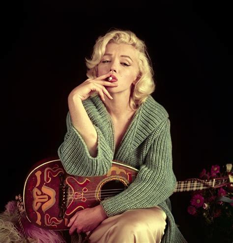 Marilyn monroe was an american actress, comedienne, singer, and model. Marilyn Monroe holding a guitar and smoking, 1950s : OldSchoolCool