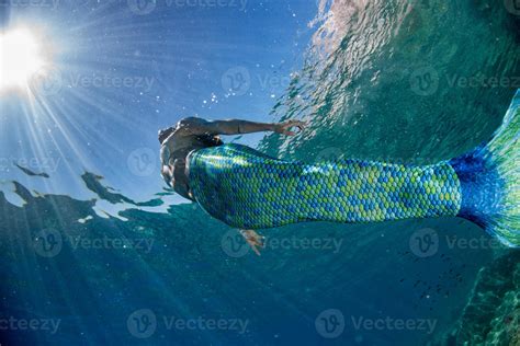 Mermaid Swimming Underwater In The Deep Blue Sea 17239002 Stock Photo