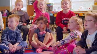 A Cute Group Of Preschool Students Sit Together In Class And Sing A