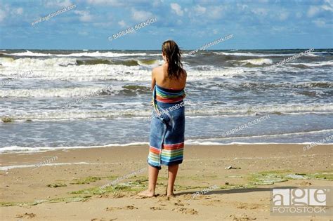 Woman Wrapped In A Towel Is Looking Out At The Sea Katwijk Aan Zee South Holland Holland