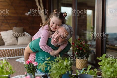Portrait Of Little Cute Daughter Hugging Her Happy Father At Home Stock