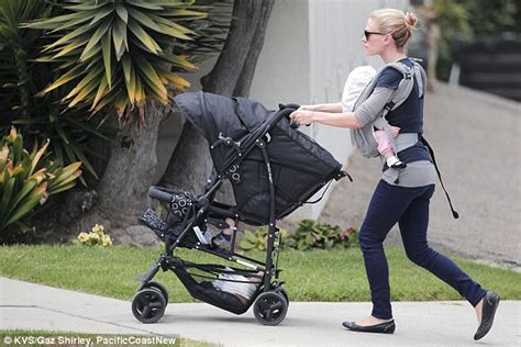 Anna Paquin Carries One Of Her Twins In A Harness As She Pushes The