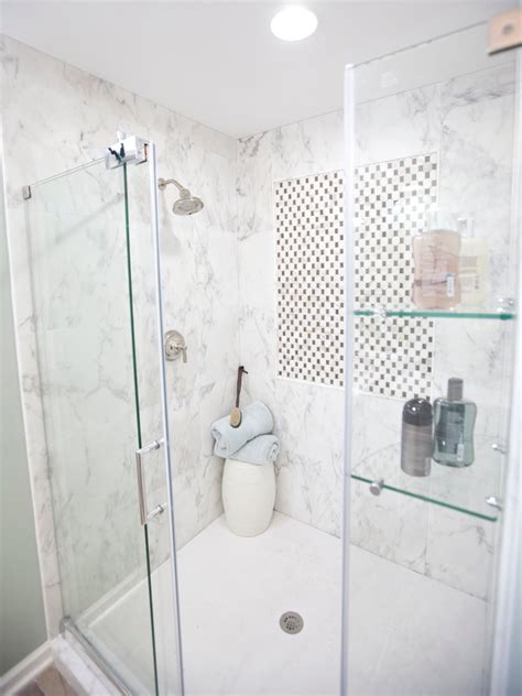 Large walk in shower features honed gray marble subway wall tiles and stacked marble tiled shower niches. Photo Page | HGTV