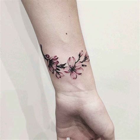 Cute Feminine Flower Armband Tattoo On Wrist Tattoo