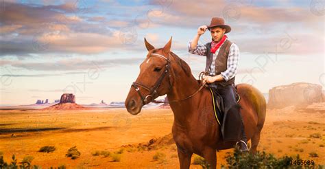 Cowboy Riding A Horse In Desert Valley Western Stock Photo 1455689
