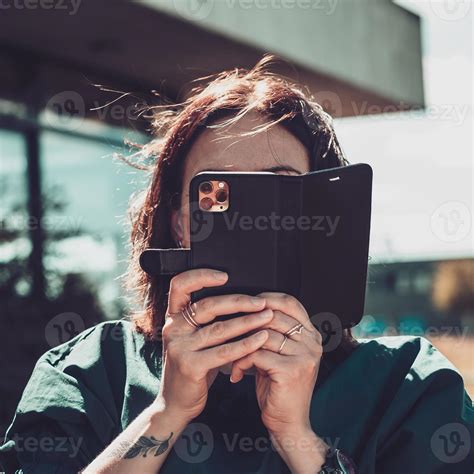 Young Woman Takes Pictures By Phone The Smartphone Covers The Face