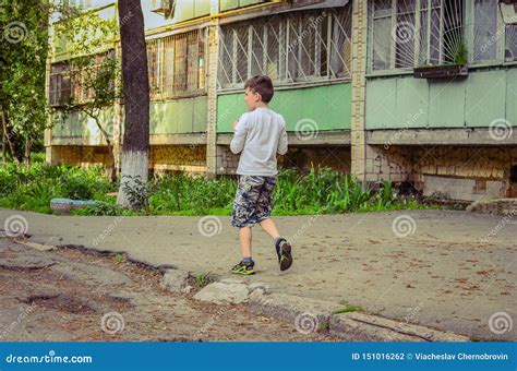 Little Boy Walks Near His Old House Stock Photo Image Of Front