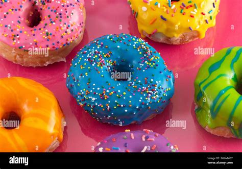 A Batch Of Rainbow Colored Glazed Donuts Stock Photo Alamy