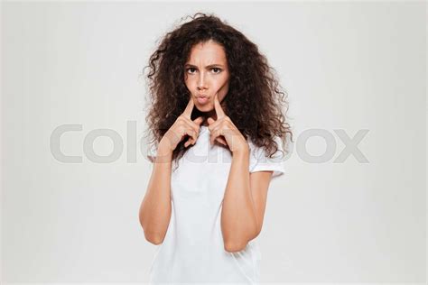 Calm Curly Woman Folding Fingers On Cheeks Stock Image Colourbox