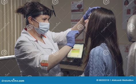 Otolaryngologist Examines A Patient In Clinic Stock Photo Image Of
