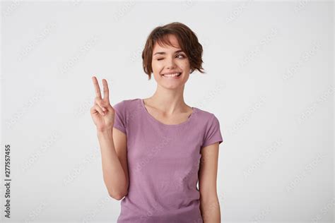 Portrait Of Cute Short Haired Young Woman In Blank T Shirt Bites Lip