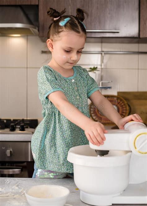 Funny Cute Little Girl Preparing Dough In The Kitchen Stock Image
