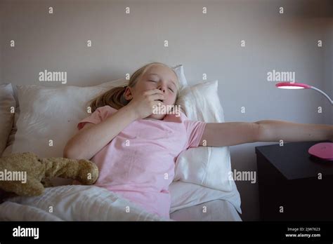 Young Girl Waking Up In Her Bedroom Stock Photo Alamy