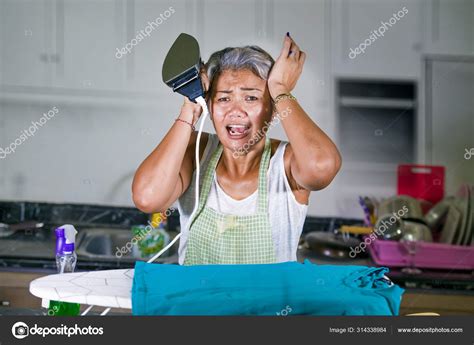 Attractive Upset And Stressed Woman 40s To 50s Ironing Tired And Unhappy At Home Kitchen Doing