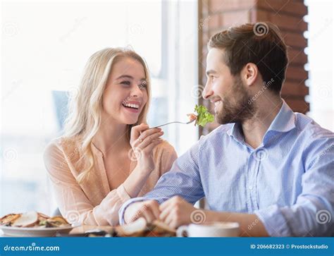 Cheerful Millennial Couple Eating Together At Coffee Shop Young Lady