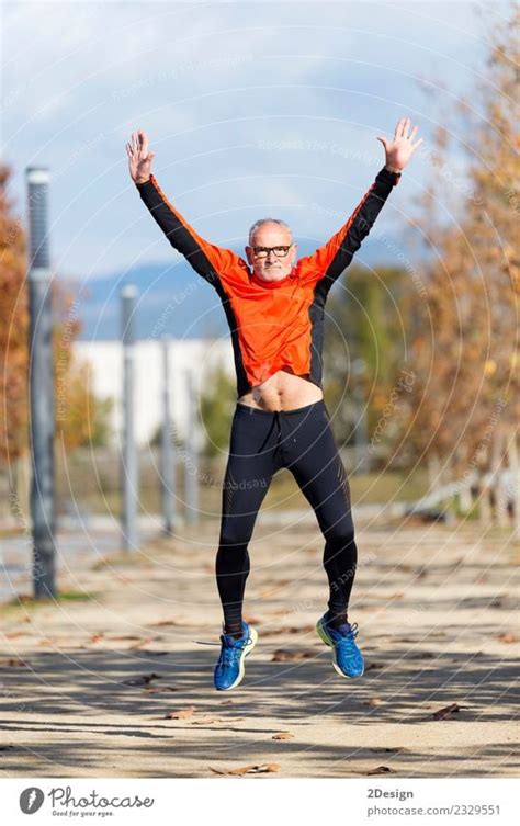Senior Runner Man Jumping Arms Up After Running A Royalty Free Stock
