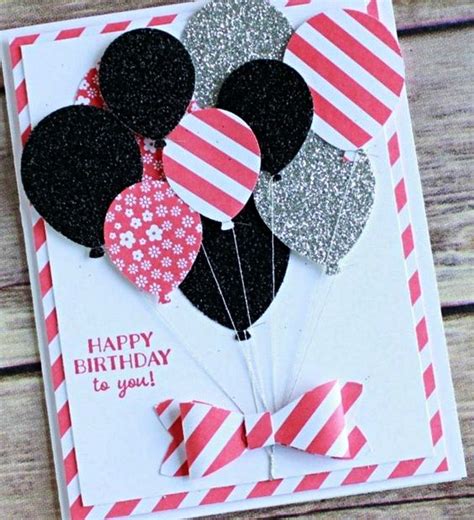 A Birthday Card With Some Balloons On It And A Bow Tie Around The