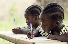african children school students writing homework doing their sitting africa desk pens holding child ethnicity whilst essay write down blue