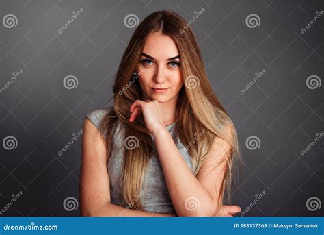 the girl holds her hand under the chin and looks straight stock image image of health