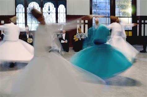 A Group Of People In White And Blue Dresses Dancing