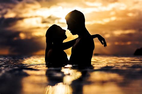 Sunset Silhouette Of Couple Kissing In Water Photo By Two Mann Studios