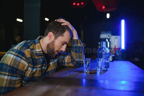 Sad Young Man Sitting At Bar Counter In Pub Upset Man Drinks Alcohol