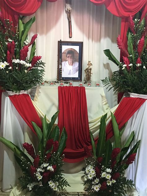 The Altar Is Decorated With Red And White Flowers Greenery And A