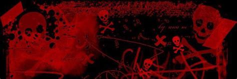 Red And Black Graffiti On The Side Of A Building With Skulls Bones And