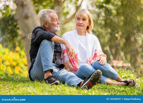Happy Senior Couple Relaxing At Park Together In Morning Time Old