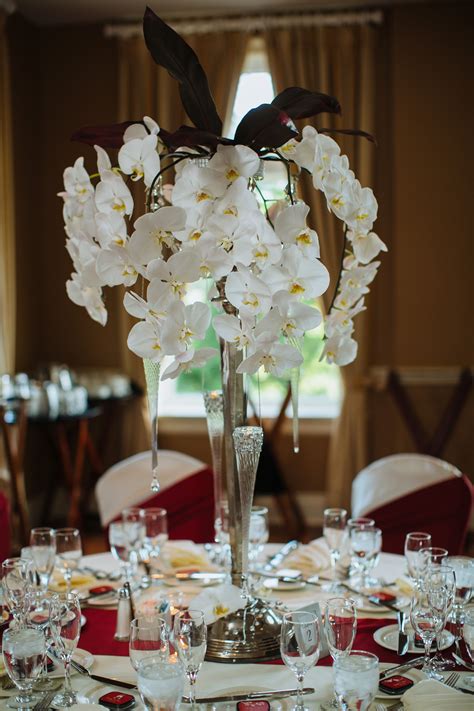 Cascading White Orchid Centerpieces | White orchid centerpiece, Orchid centerpieces, White orchids