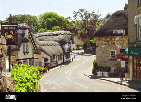 Winding Road Through Pittoresque Old Village With Thatched Roof Houses