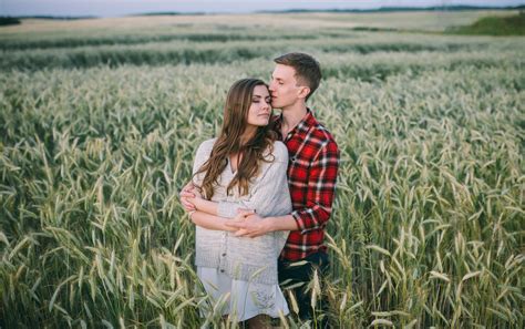 Man And Woman Kissing On The Wheatfield · Free Stock Photo