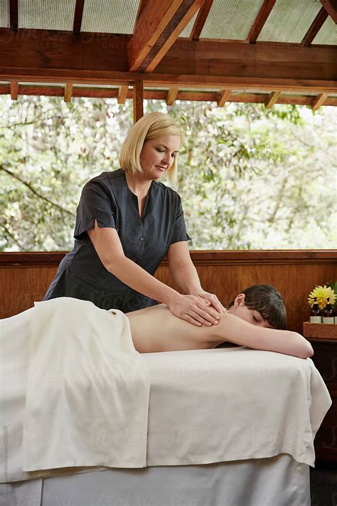 Woman Relaxing At Spa Receiving A Massage From Massage Therapist Del