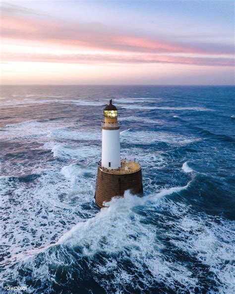 Waves Hitting A Lighthouse In Scotland Premium Image By