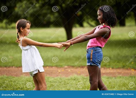 Children Playing Ring Around The Rosie In Park Stock Photo Image Of