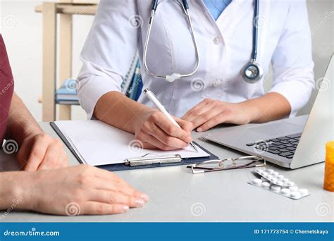 Doctor Consulting Patient In Clinic Medical Service Stock Photo