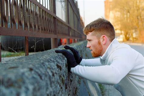 Ginger Sportsman Doing Push Ups Near Fence By Danil Nevsky