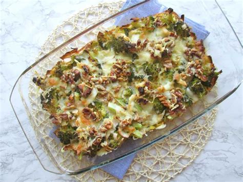 A Casserole Dish With Broccoli Cheese And Other Toppings On Top