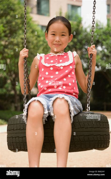 Portrait Of A Girl Swinging On A Tire Swing Stock Photo Alamy